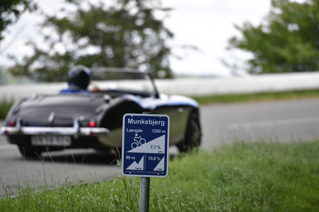 Hotelejer Hans Geschwendtner fra Munkebjerg Hotel stiller vanen tro op i sin Austin-Healey 3000 Mk 1 fra 1959. Her passerer han i et tidligere løb et skilt, der viser banens sværhedsgrad.
(Foto: Michael Eisenberg)